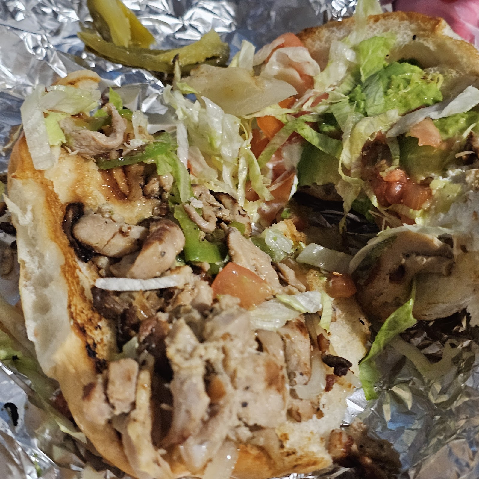 Grilled torta sandwich with lettuce, tomato, and guacamole